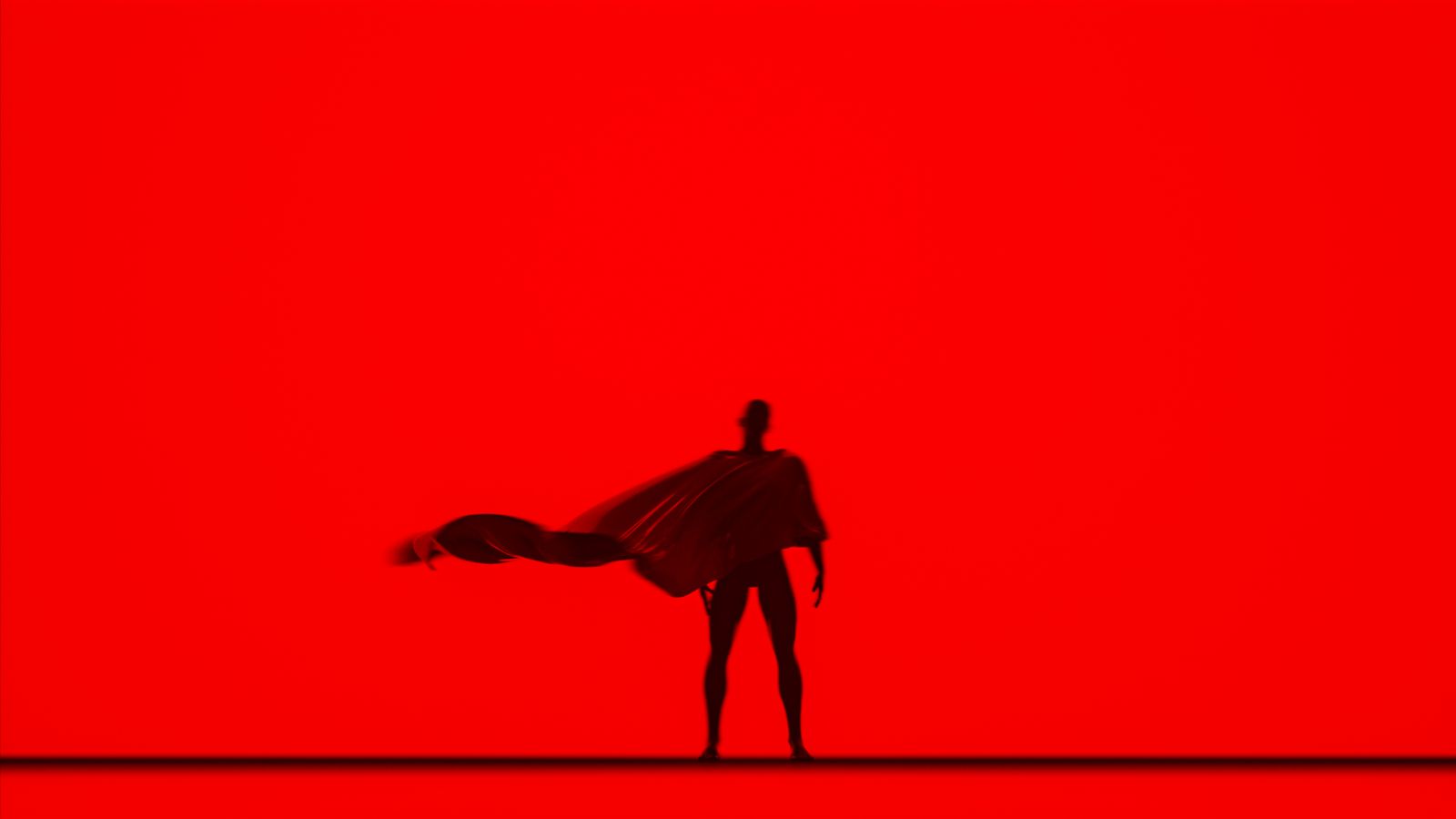 Silhouette d'une personne avec une cape flottante, sur fond rouge.